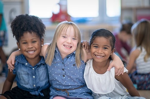 Children smiling and looking at the camera